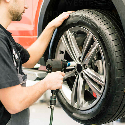 Mechanic fitting tyres on a hoist at Elite Brake & Mechanical Springvale workshop